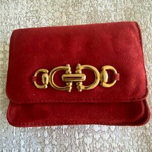 Red suede wallet with interior key ring and mirror and back zipper compartment.